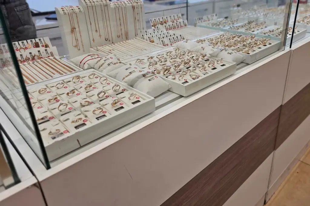 A display of various rings and bracelets highlighting the importance of presentation when selling jewelry.